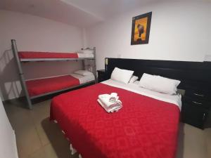 a bedroom with two bunk beds and a red blanket at Hotel Artico in Mar del Plata