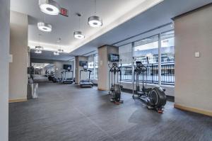 ein Fitnessstudio mit Laufbändern und Crosstrainern in einem Gebäude in der Unterkunft Stunning 2 BD in heart of Toronto with Parking in Toronto
