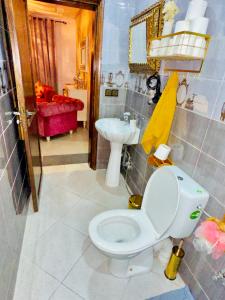 a bathroom with a toilet and a sink at Luxurious Vacation Apartment Essaouira in Diabat +19 photos
