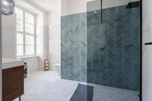 a bathroom with a shower with a glass door at Styled Apartment Close To The River Danube. in Budapest +10 photos