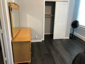 a dressing room with a mirror and a dresser at Private 2-bedroom with free parking and direct bus to NYC Manhattan only 2 blocks away in Linden