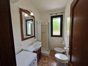 a bathroom with a sink and a toilet and a shower at Appartamento Dune in Santa Lucia