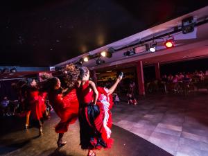 a group of women dancing on a dance floor at BlueBay Lanzarote in Costa Teguise +26 photos