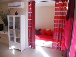 a room with a couch with red pillows at Residence Borgo Punta Villa in La Maddalena