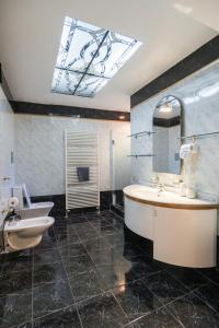 a bathroom with a tub and a sink and a mirror at GRAND SUITE by F & G in Kastoria +47 photos