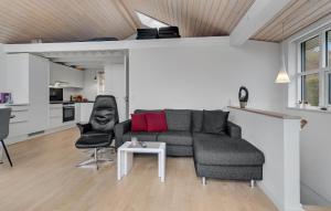 a living room with a couch and a table at 3 Bedroom Amazing Home In Mariager in Mariager