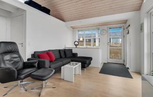 a living room with a couch and a chair at 3 Bedroom Amazing Home In Mariager in Mariager