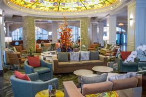 a lobby with couches and tables and a stained glass ceiling at Gaylord Opryland Resort & Convention Center in Nashville
