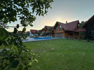 a house with a yard with a swimming pool at Guest House Sofia in Bukovel