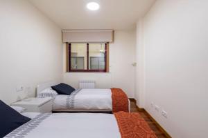 Łóżko lub łóżka w pokoju w obiekcie Apartamento Lua
