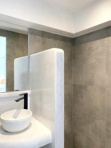 a bathroom with a white sink and a mirror at Cycladic Nest in Dryopida in Kithnos +29 photos