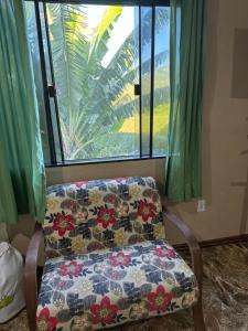 uma cadeira sentada em frente a uma janela em Loft praia do pontal, arraial do cabo Rj em Arraial do Cabo