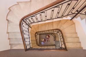 a spiral staircase in a home with a wooden stair case at Hotel Al Prato in Padova