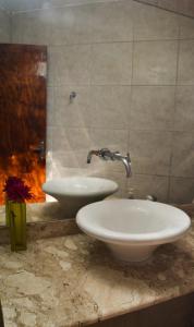 a bathroom with a white sink and a sink at Pousada Prime Center in Pipa +26 photos