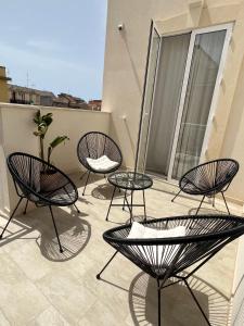 a patio with chairs and tables on a balcony at Sciantusa in Avola