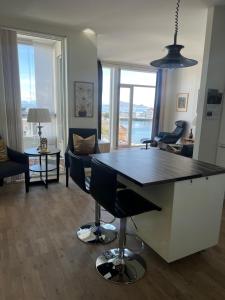 a living room with a table and chairs and a living room at Svolvær Havn Apartments in Svolvær