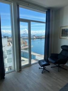 a room with a large window with a view of the water at Svolvær Havn Apartments in Svolvær