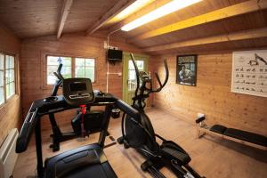 a gym with two exercise bikes in a room at Bow Cottage in Paignton