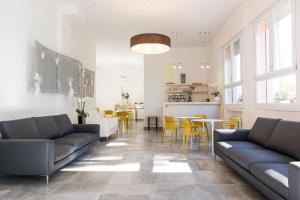 a living room with couches and a table and chairs at Hotel Al Prato in Padova