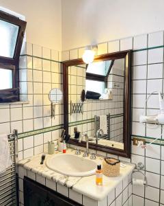 a bathroom with a sink and a mirror at Villa des Arts - Taormina in Taormina
