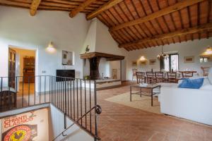 an open living room and dining room with wooden ceilings at Private Chianti Hill Residence in Vagliagli