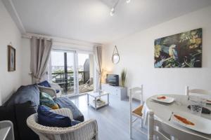 a living room with a couch and a table at Résidence La Commanderie - maeva Home - Appartement vue sur le port 2 pièces 4 personnes - Sélection - super Home MAE-7721 in Arzon