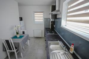 a kitchen with a sink and a table and a window at Eden House 188A in Târgu-Mureş +35 photos