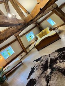 a bedroom with a bed in a room with wooden ceilings at Das GANZE Chateau Thor - bis zu 22 Personen in Lontzen