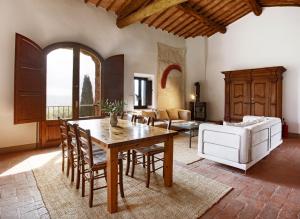 a living room with a table and a couch at Private Chianti Hill Residence in Vagliagli