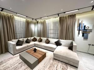 a living room with a couch and a coffee table at Private house Sheikh Zayed Egypt in 6th Of October