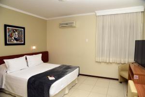 Postel nebo postele na pokoji v ubytování Cedro Hotel
