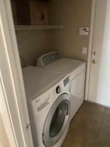 a washer and dryer in a small room at Master Bedroom inside a Gorgeous Home in a Beautiful Neighborhood in Las Vegas