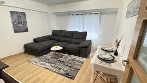 a living room with a couch and a table at Aly Home in Castellón de la Plana