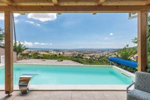 a swimming pool with a view from a house at Barefoot Summer House in Klis