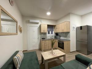 a kitchen with a couch and a table in a room at stefanidis apartments in Kalymnos