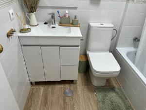 a bathroom with a toilet and a sink and a tub at Casa Gran Cinema in Sanlúcar de Barrameda +28 photos