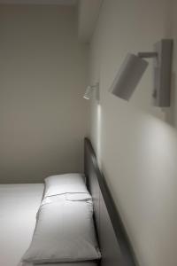Postel nebo postele na pokoji v ubytování Meraki Hotel
