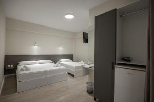 Postel nebo postele na pokoji v ubytování Meraki Hotel