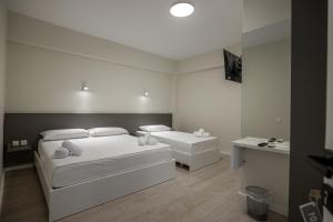 Postel nebo postele na pokoji v ubytování Meraki Hotel