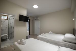 Postel nebo postele na pokoji v ubytování Meraki Hotel