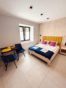 a bedroom with a bed and a table and chairs at Studio dla 2 osób Tatra-Dream in Zakopane +15 photos