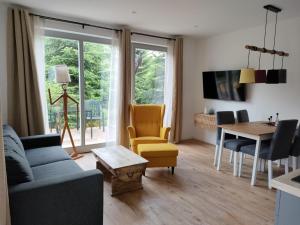 a living room with a couch and a table at Alpaka-Lodge in Kirchwahlingen