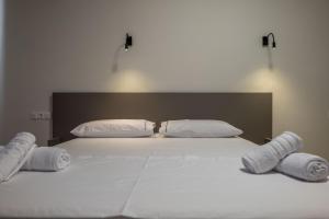 Postel nebo postele na pokoji v ubytování Meraki Hotel