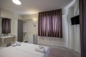 Postel nebo postele na pokoji v ubytování Meraki Hotel