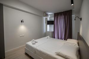 Postel nebo postele na pokoji v ubytování Meraki Hotel