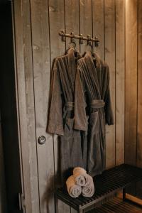 a coat and towels hanging on a wall at ANDO Villa with wood stove sauna in Selgas