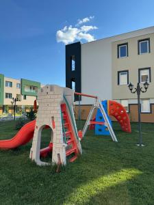 a playground with a slide and a play structure at Libertatii Gardens Poolside AIRPORT&THERME in Otopeni