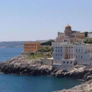 a large white building on an island in the water at Villetta in Centro Storico - Chalet in Old Town in Maglie