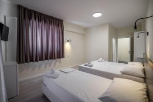 Postel nebo postele na pokoji v ubytování Meraki Hotel