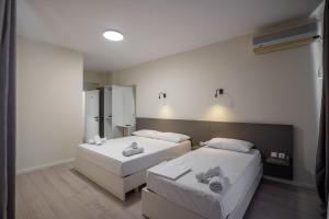 Postel nebo postele na pokoji v ubytování Meraki Hotel